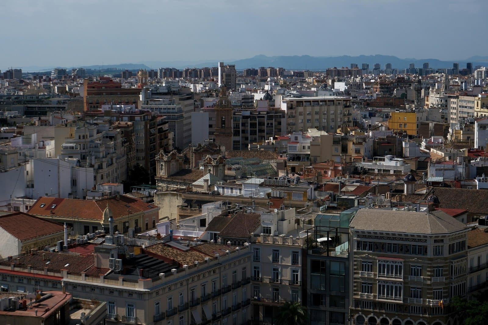 A dense cityscape under a cloudy sky.