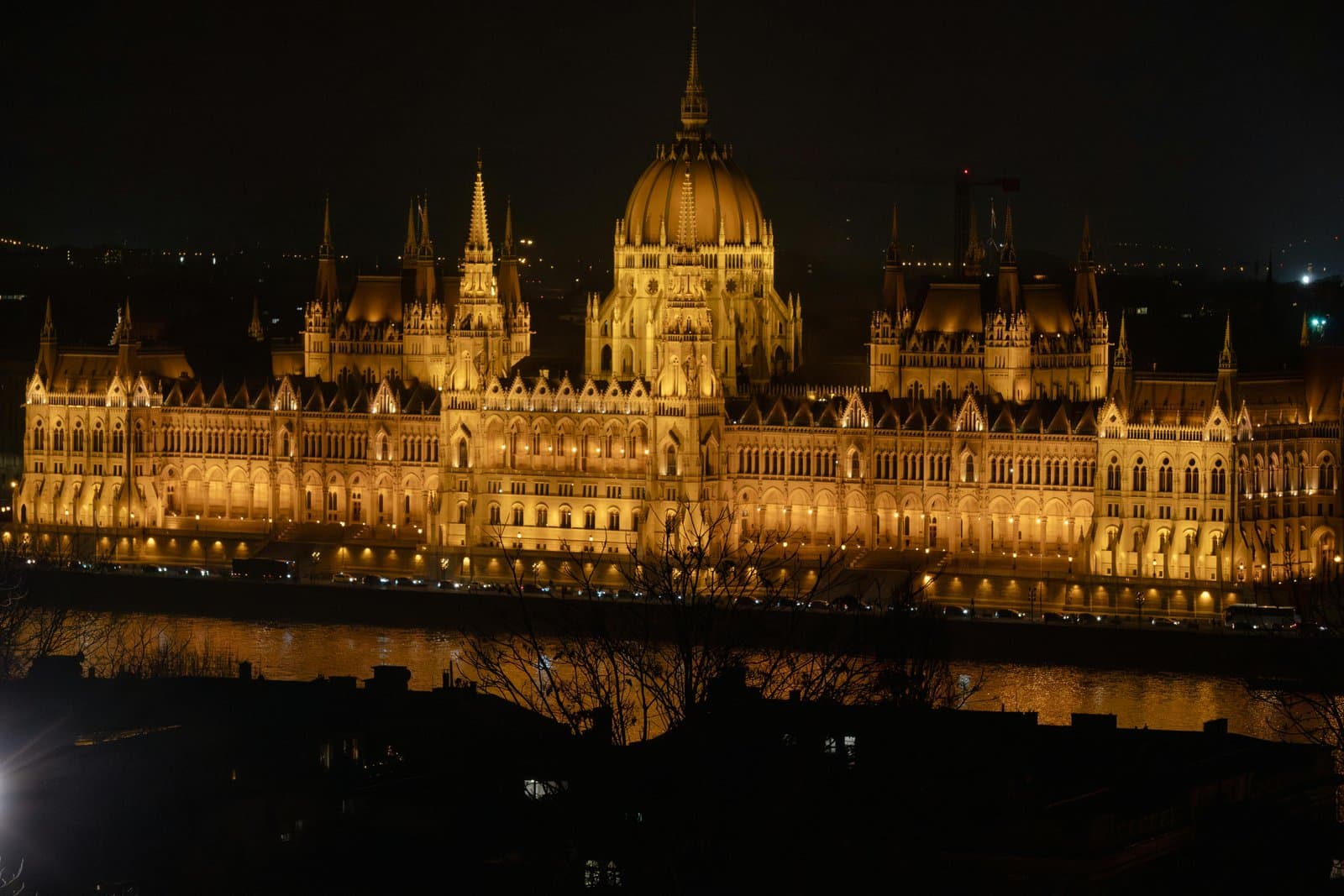 A stunning view of the illuminated Hungarian Parliament Building at night in Budapest.