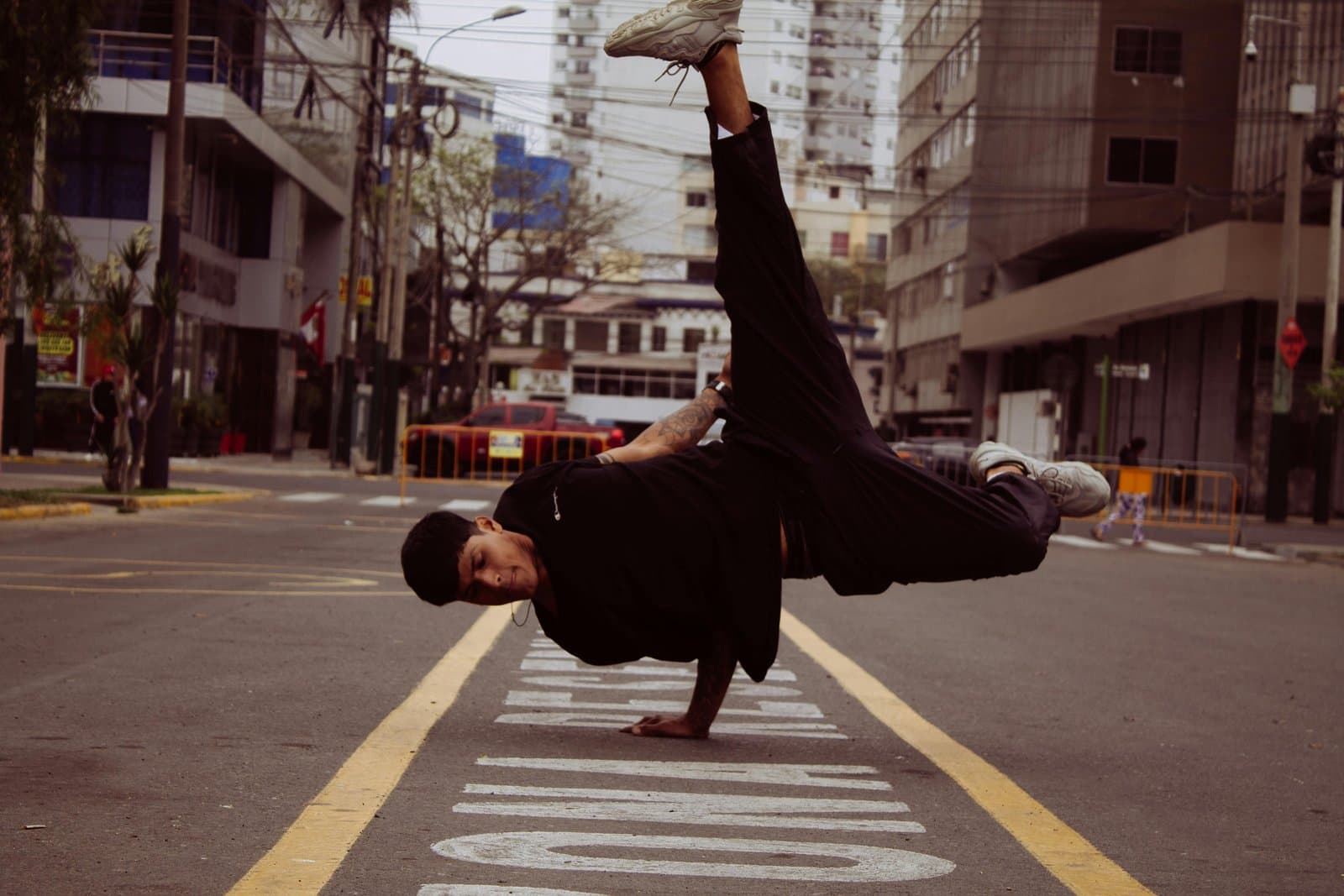 Urban street dancer performs impressive breakdancing move in downtown Lima, Peru.