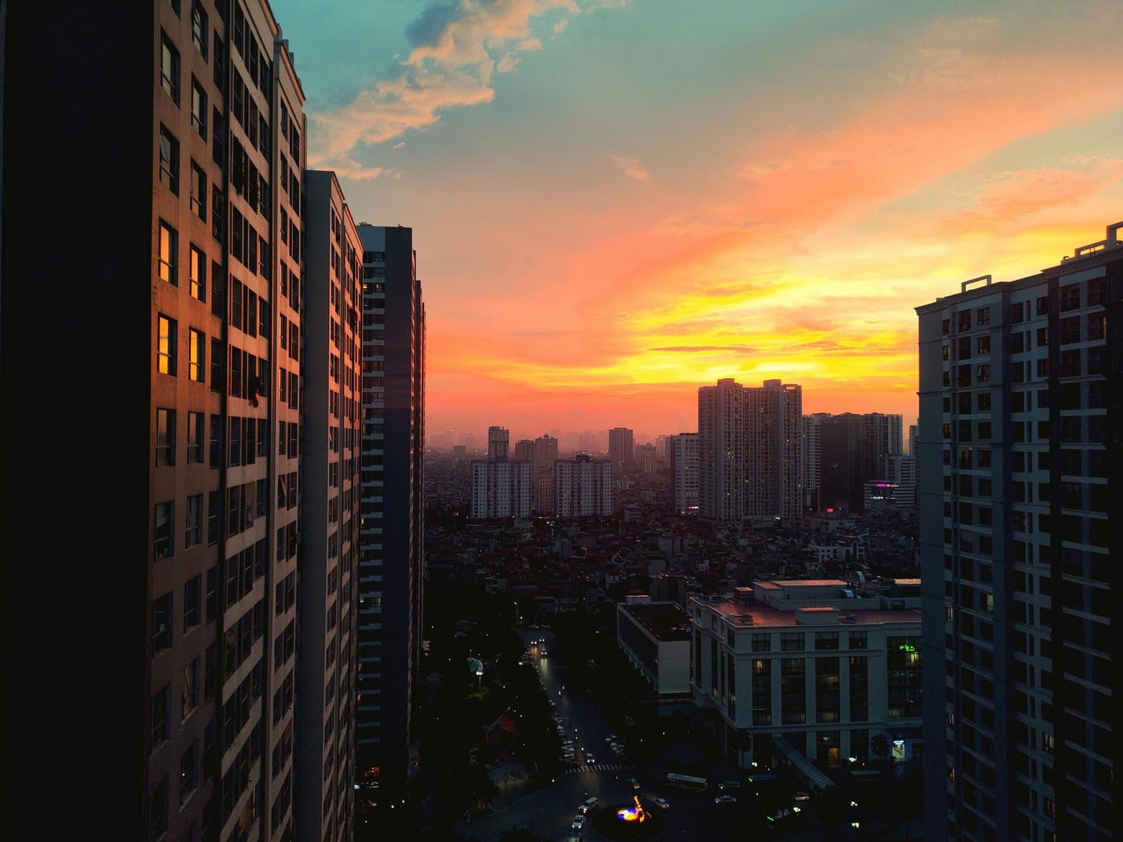 Breathtaking view of Hanoi's cityscape at sunset with vibrant hues and urban architecture.